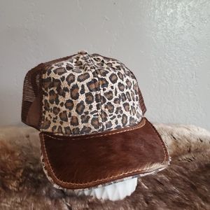 Ball cap with hand-sewn leather patch on brim